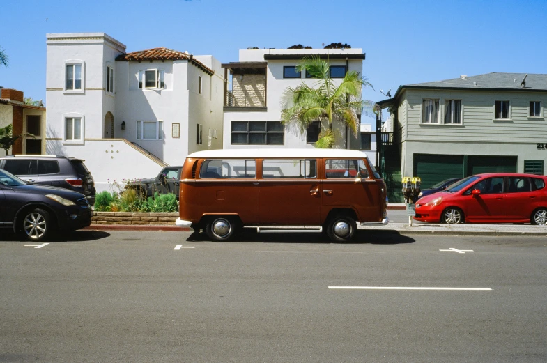 an old vw bus parked on the side of the street