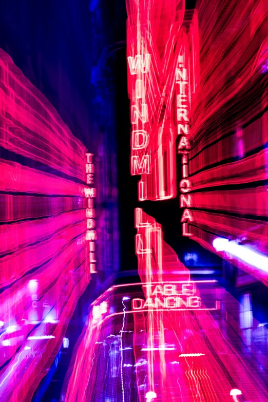 long exposure pograph of neon lights in a dark room