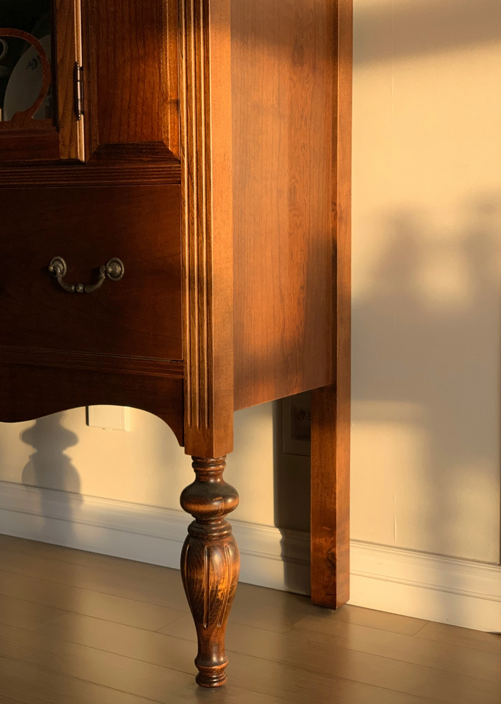 a drawer sitting on the side of a wooden dresser