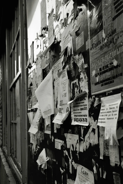 some papers and posters on a wall