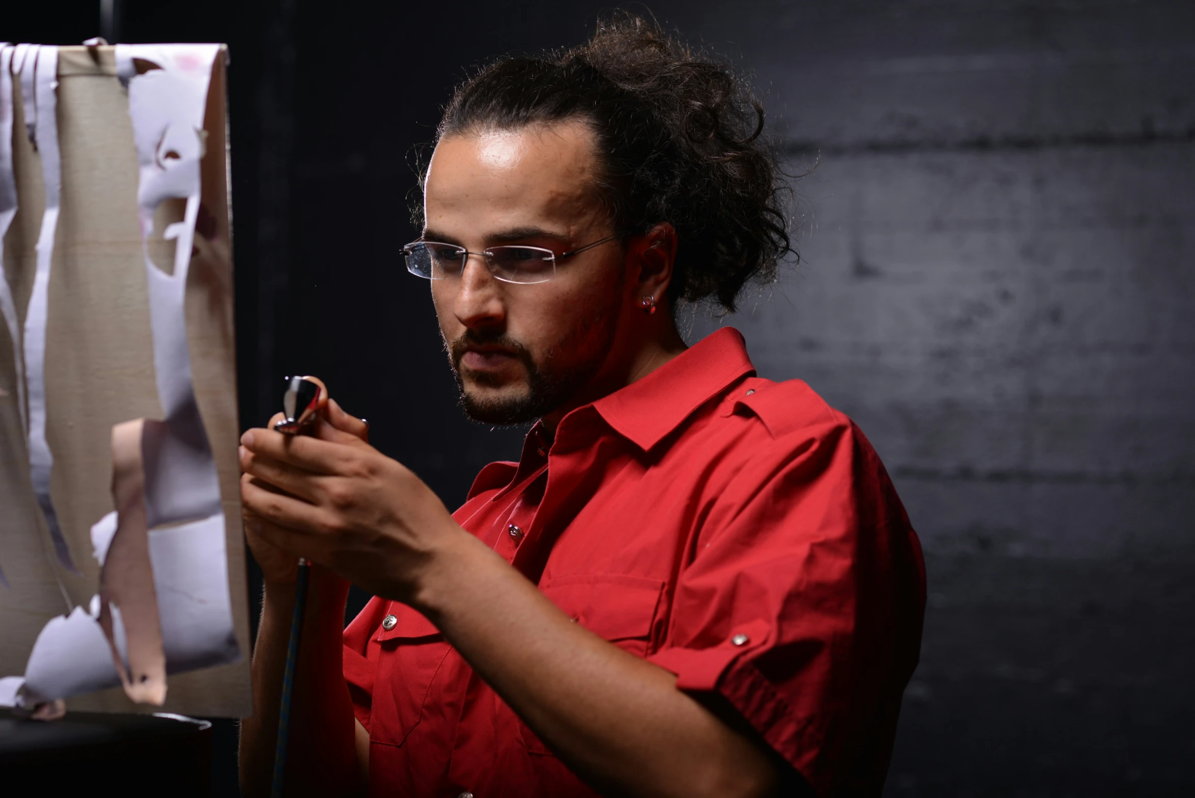 a man is holding a cellphone and looking at it