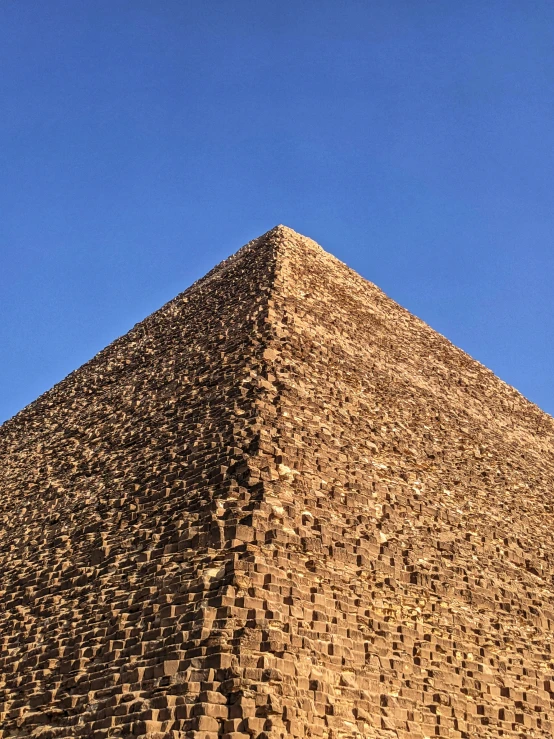 a large ancient pyramid on a bright day