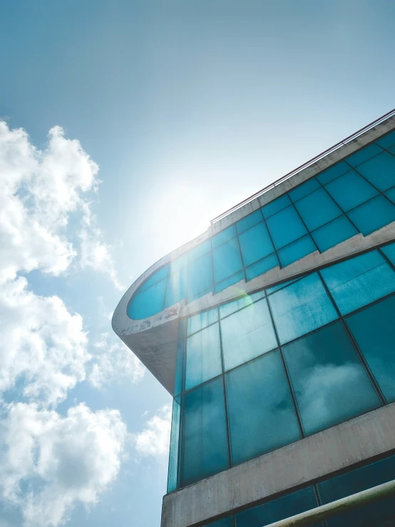 an upward view of the glass and metal front portion of a building