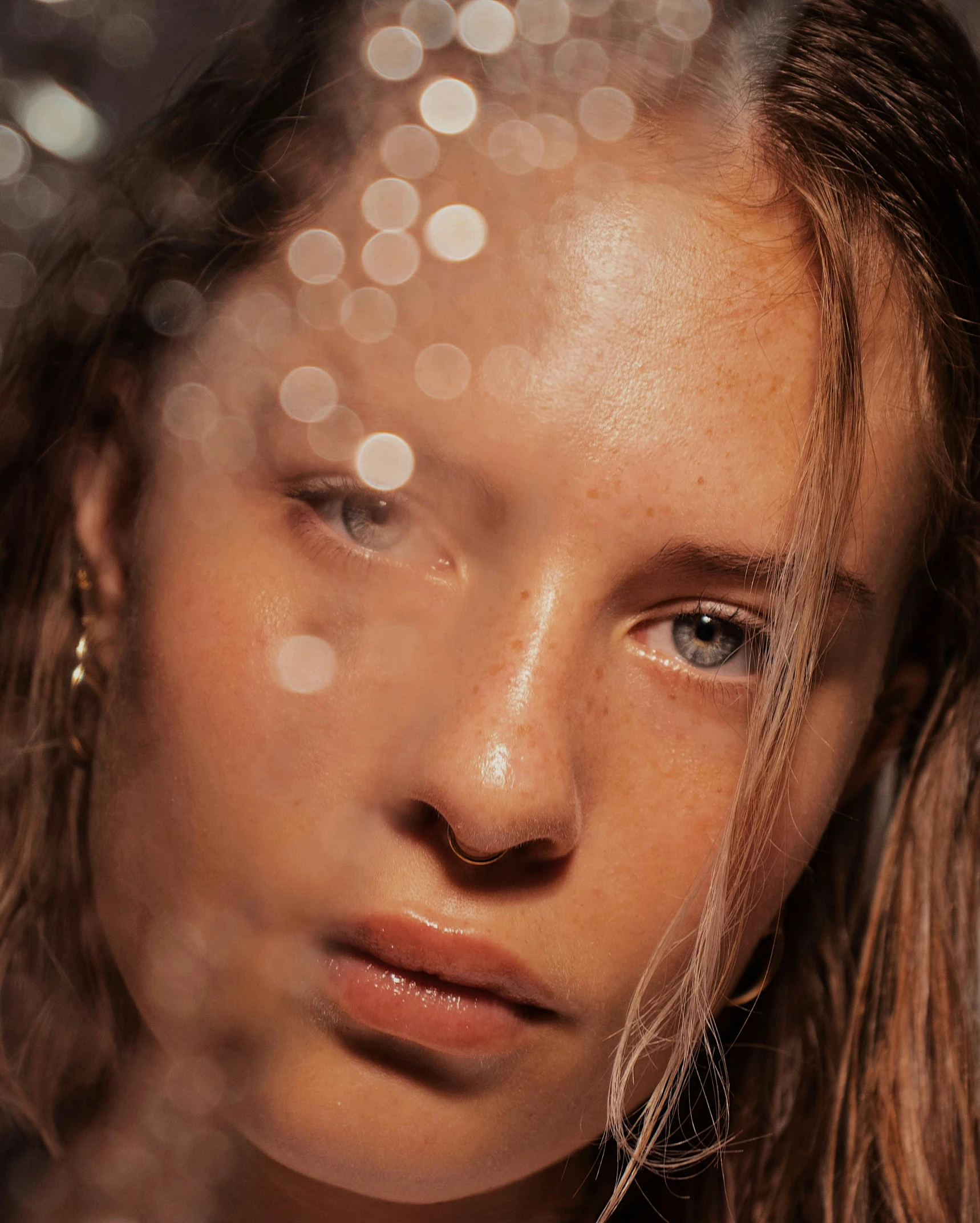 a girl with eyes closed staring at the camera