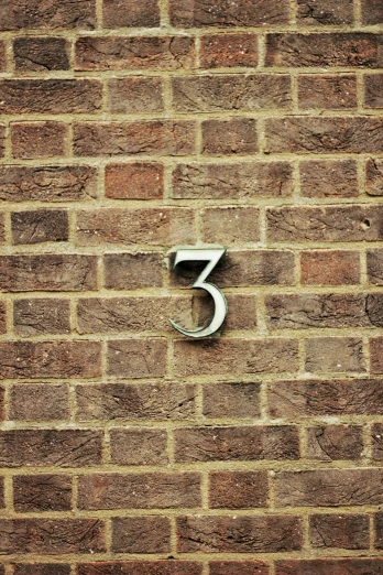 the number seven on a brick wall with white space