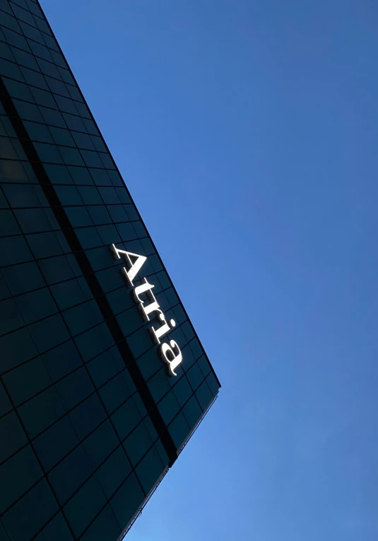 the sign of a tall building against a blue sky