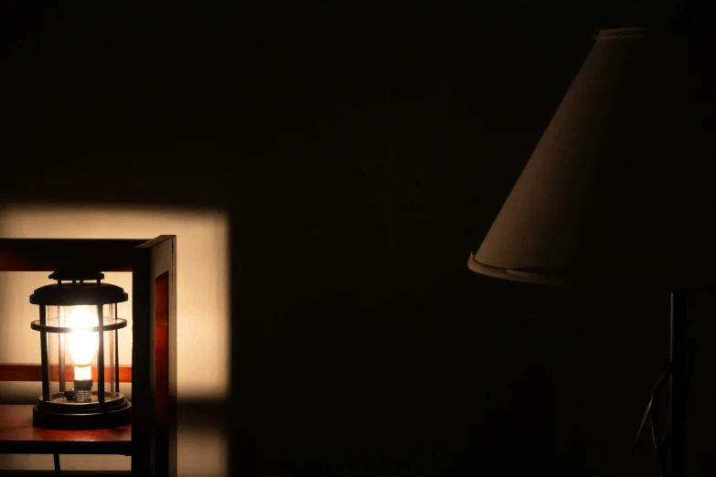 a small lamp sitting on a wooden side table