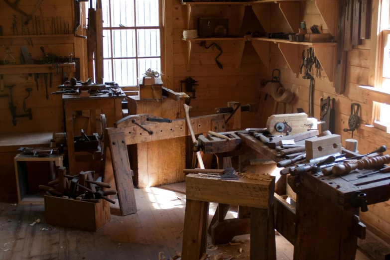 many tools sit on a work bench in an open room