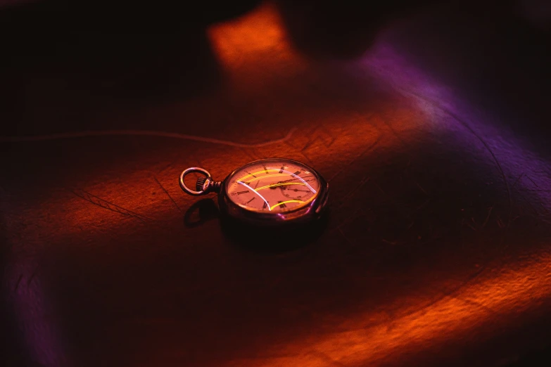 a pocket watch on a table top