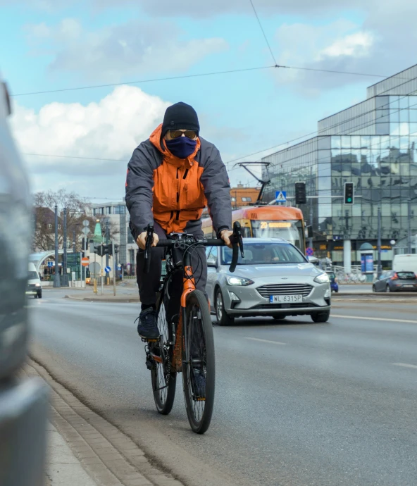 a person riding a bike down a road