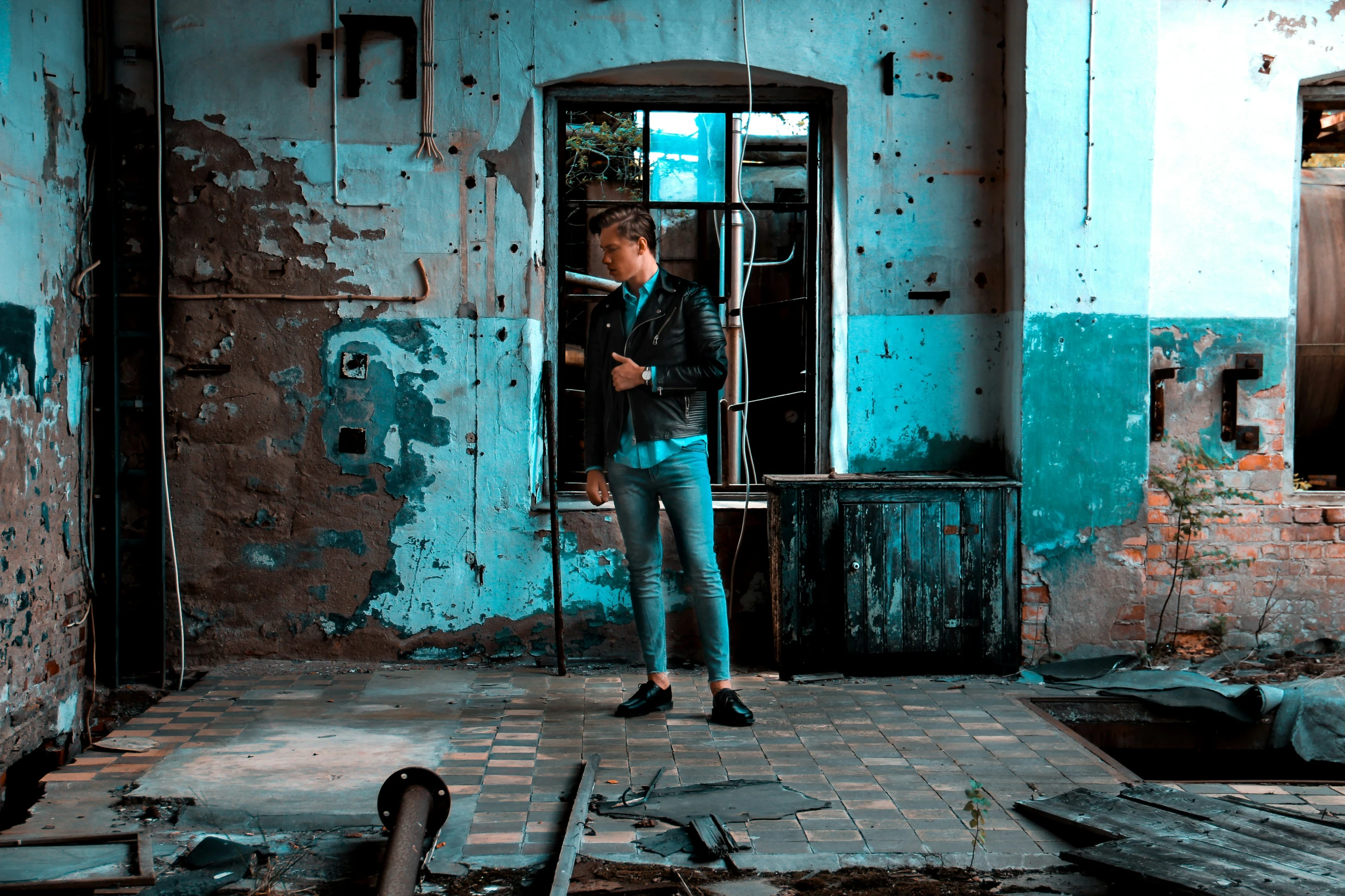 a person standing in an empty room with broken walls