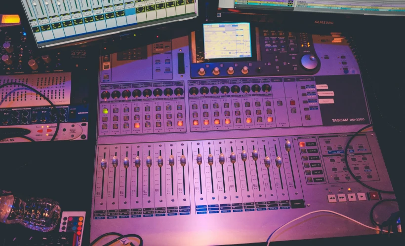 a sound board and various controls are on a desk