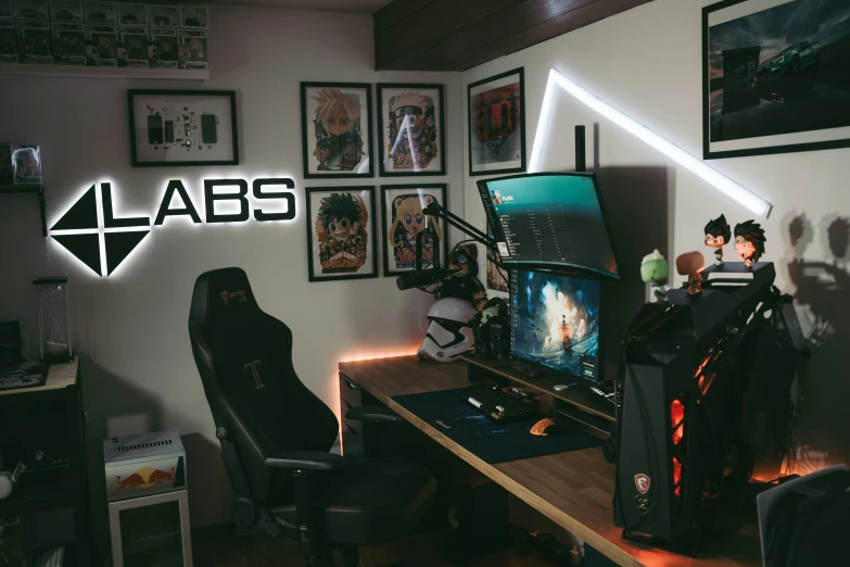 a gaming room that has an illuminated logo on the wall