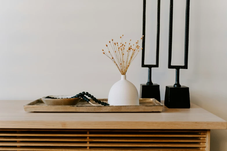 two vases sitting on a table near each other