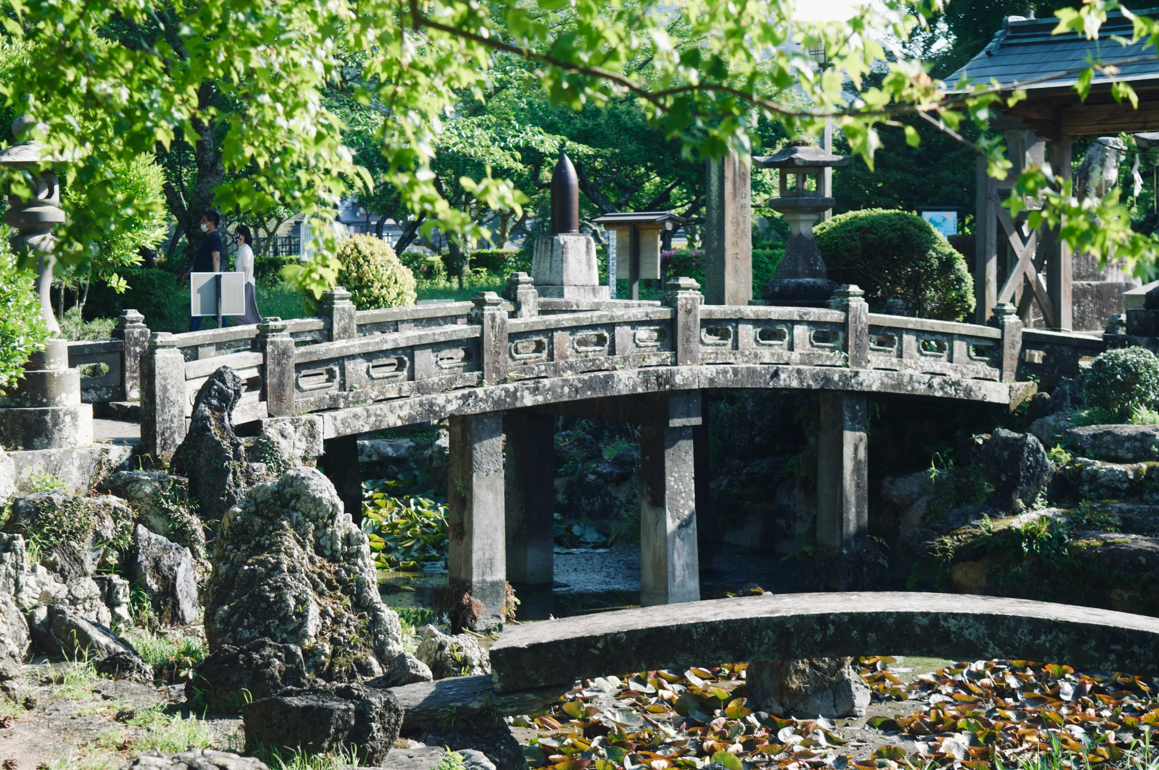 a bridge with statues and flowers next to each other