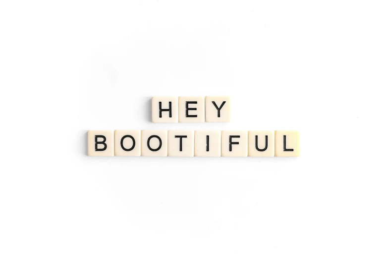 the word hey botiful spelled with wooden letters