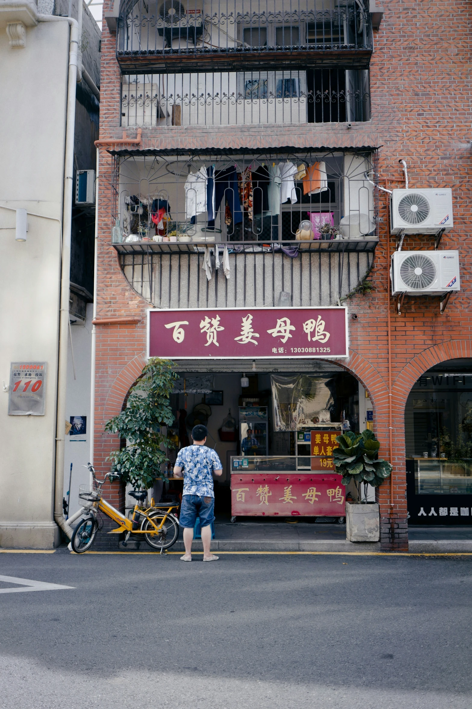 a man standing in front of an old brick building