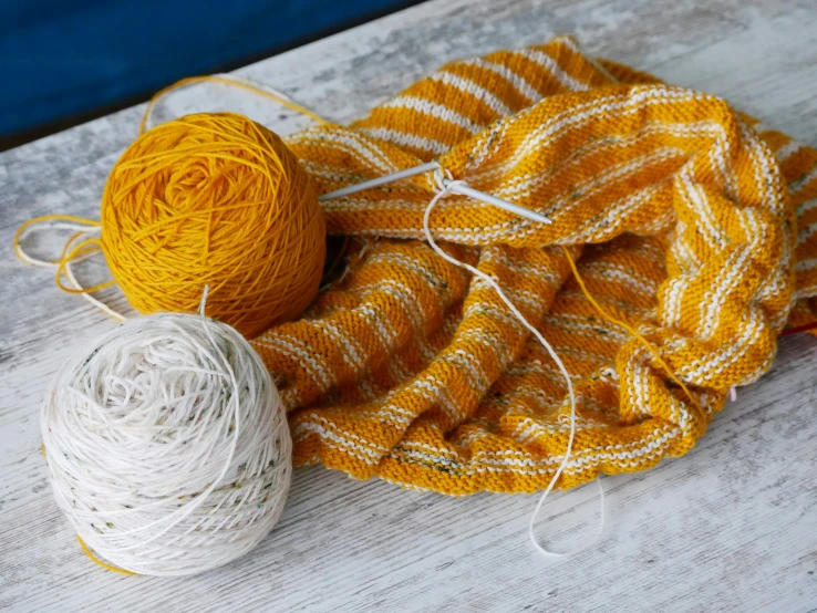 yarns and balls are on the wooden table