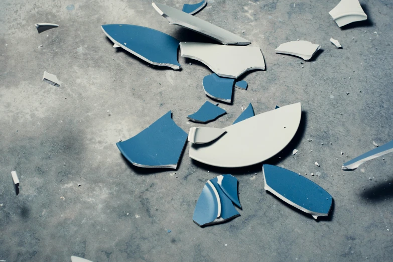 blue and white glass shards on the ground