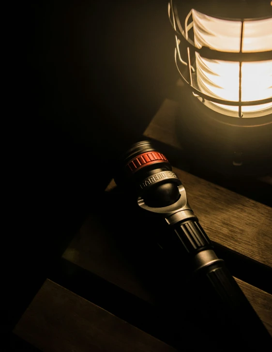 a hairdryer sitting next to a lamp on a wooden table