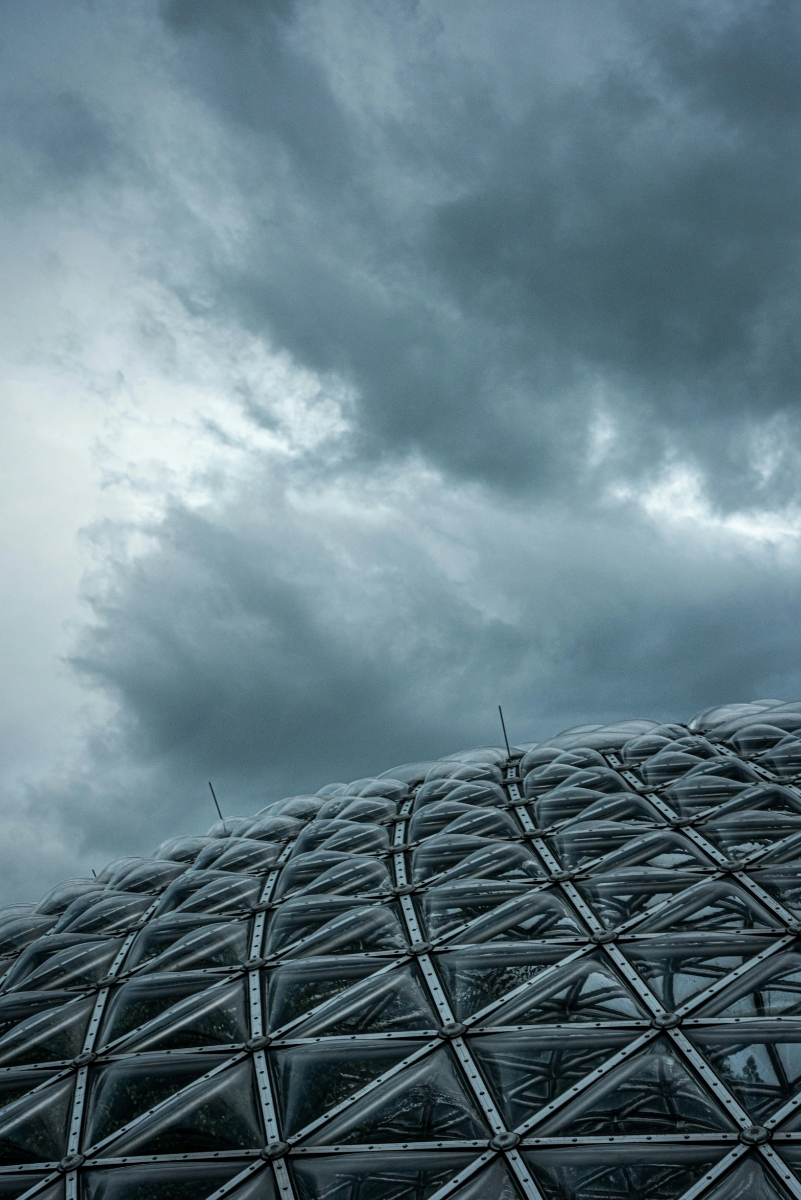 a tall metal structure under a cloudy sky