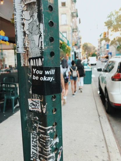 a street pole with the words you will be okay written on it