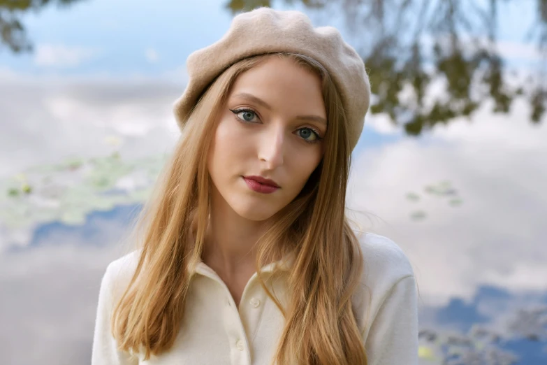 woman with long hair and hat posing for camera