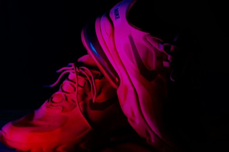 a pair of shoes in the dark on a table