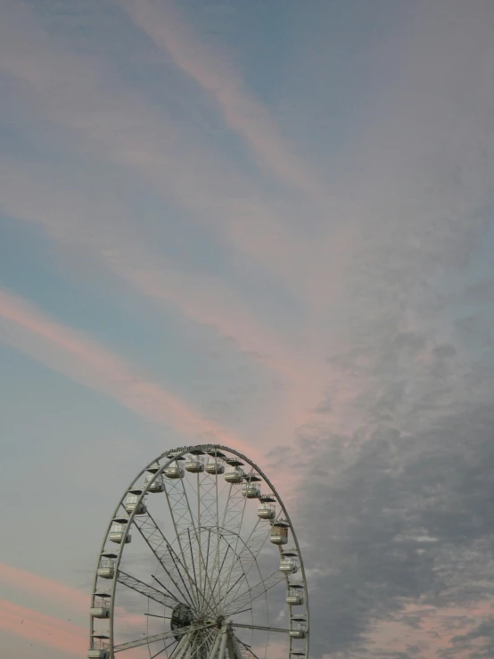 there is a ferris wheel sitting on the beach