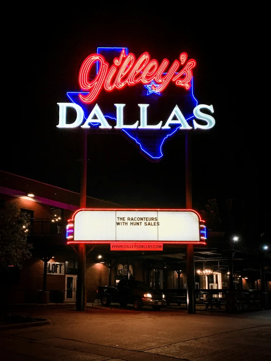 a building sign sitting outside at night