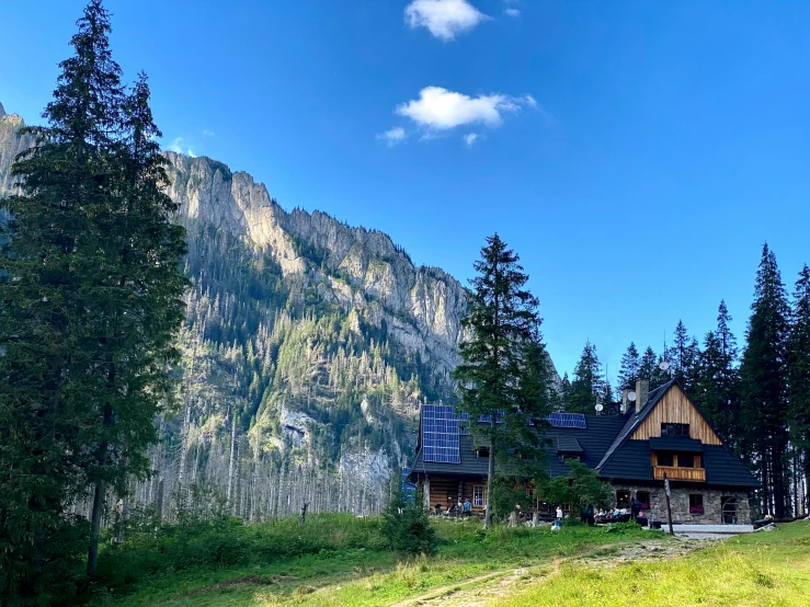 a house that is on a hill in the woods