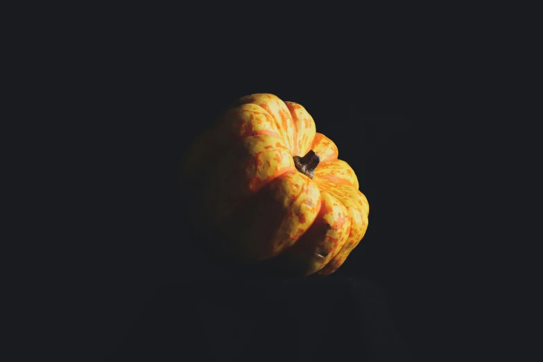 an orange that is sitting in the dark