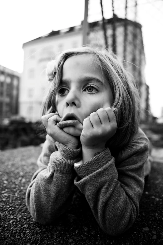 a  posing with her arms over her mouth