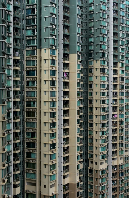 tall buildings with balconies are painted blue and beige