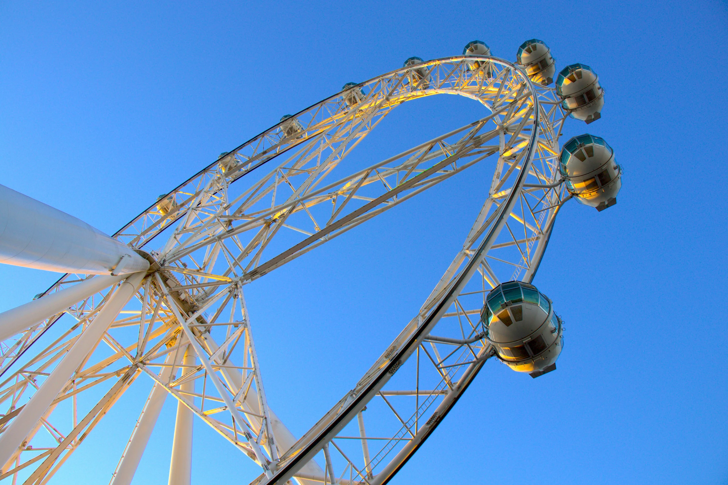 a ferris wheel with some blue sky in the background