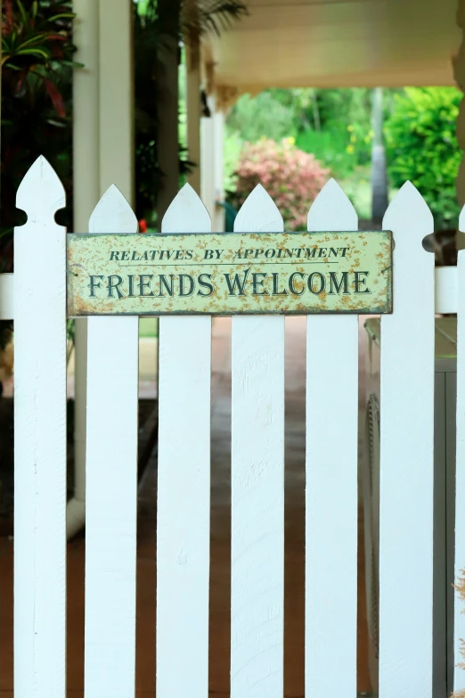 a wooden fence is decorated with the words friends welcome