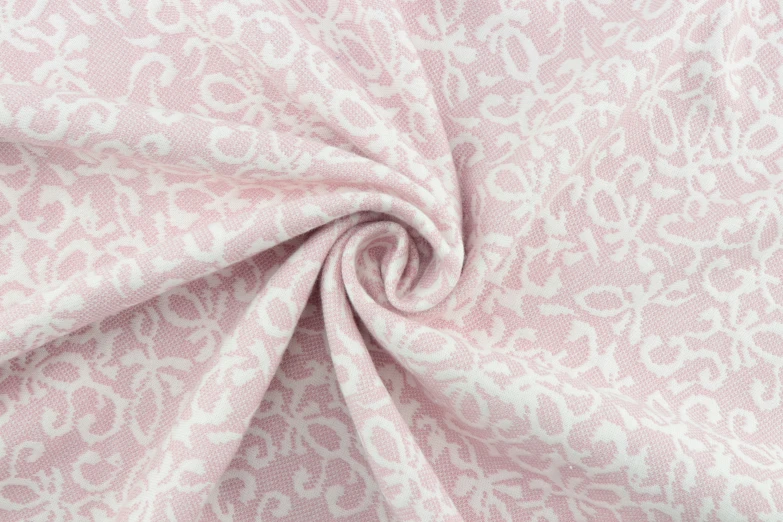 a pink and white fabric with large patterns