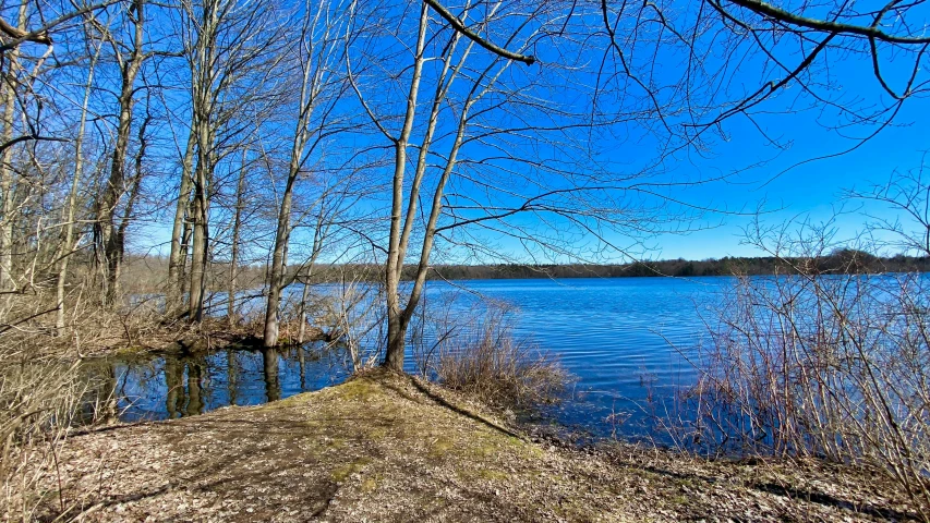 a bench near a lake sitting on top of a hill