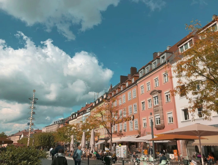 an outdoor square with buildings and a cloudy sky