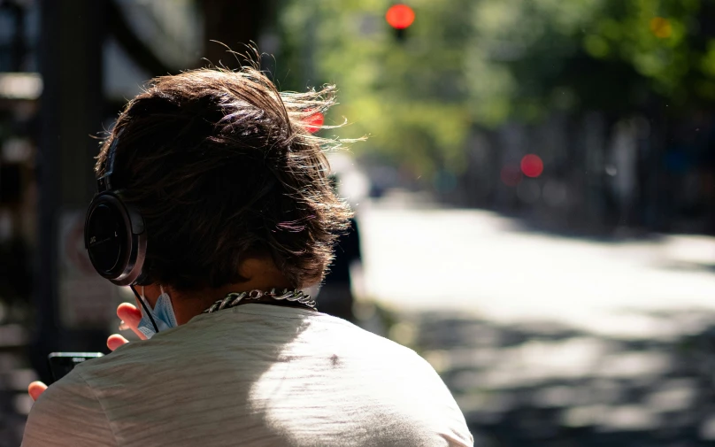 the back of a woman holding a phone to her ear