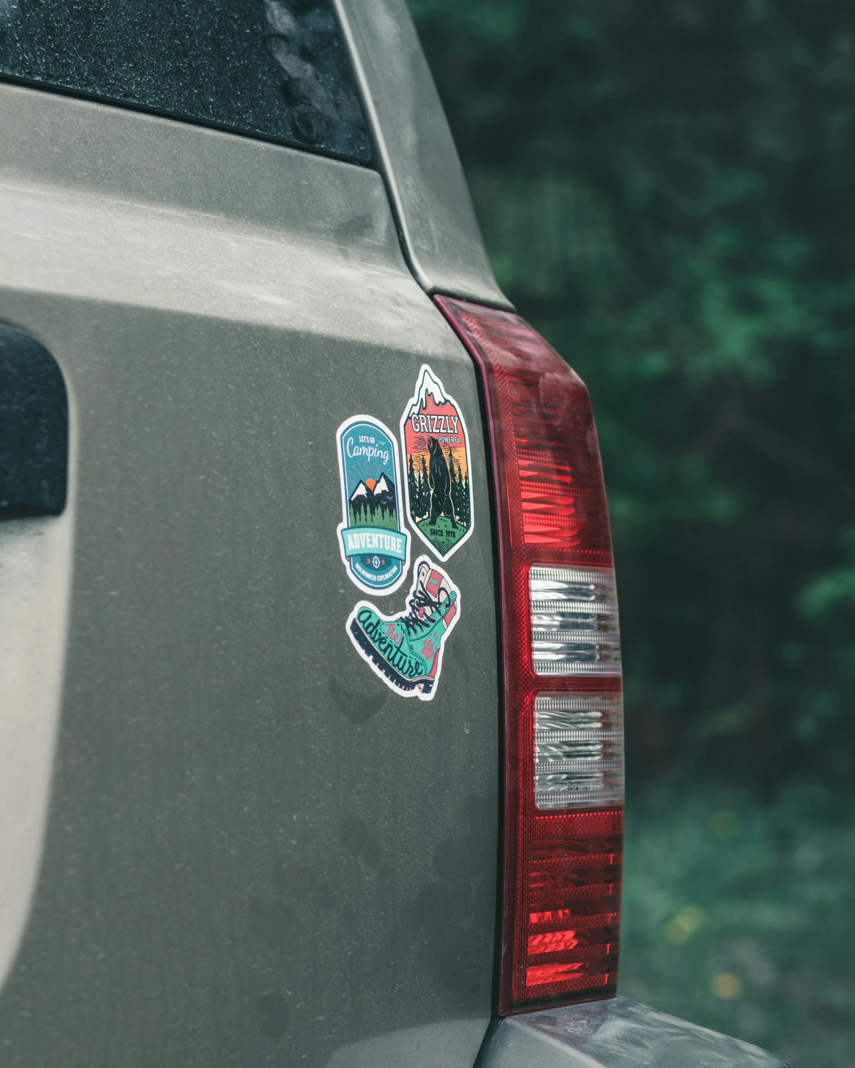 a sticker on the back of a car in the woods