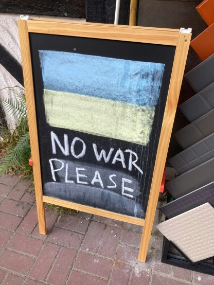 a sign is near a railing saying no war please