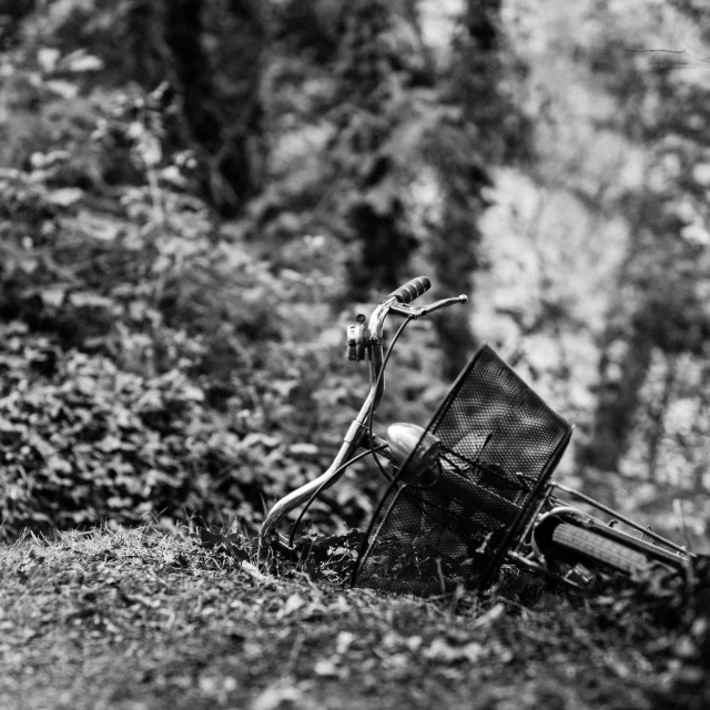 a motorcycle laying on its side in the grass