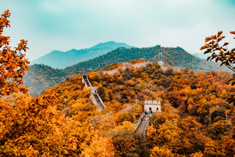 an overview of the great wall of china with fall colored trees