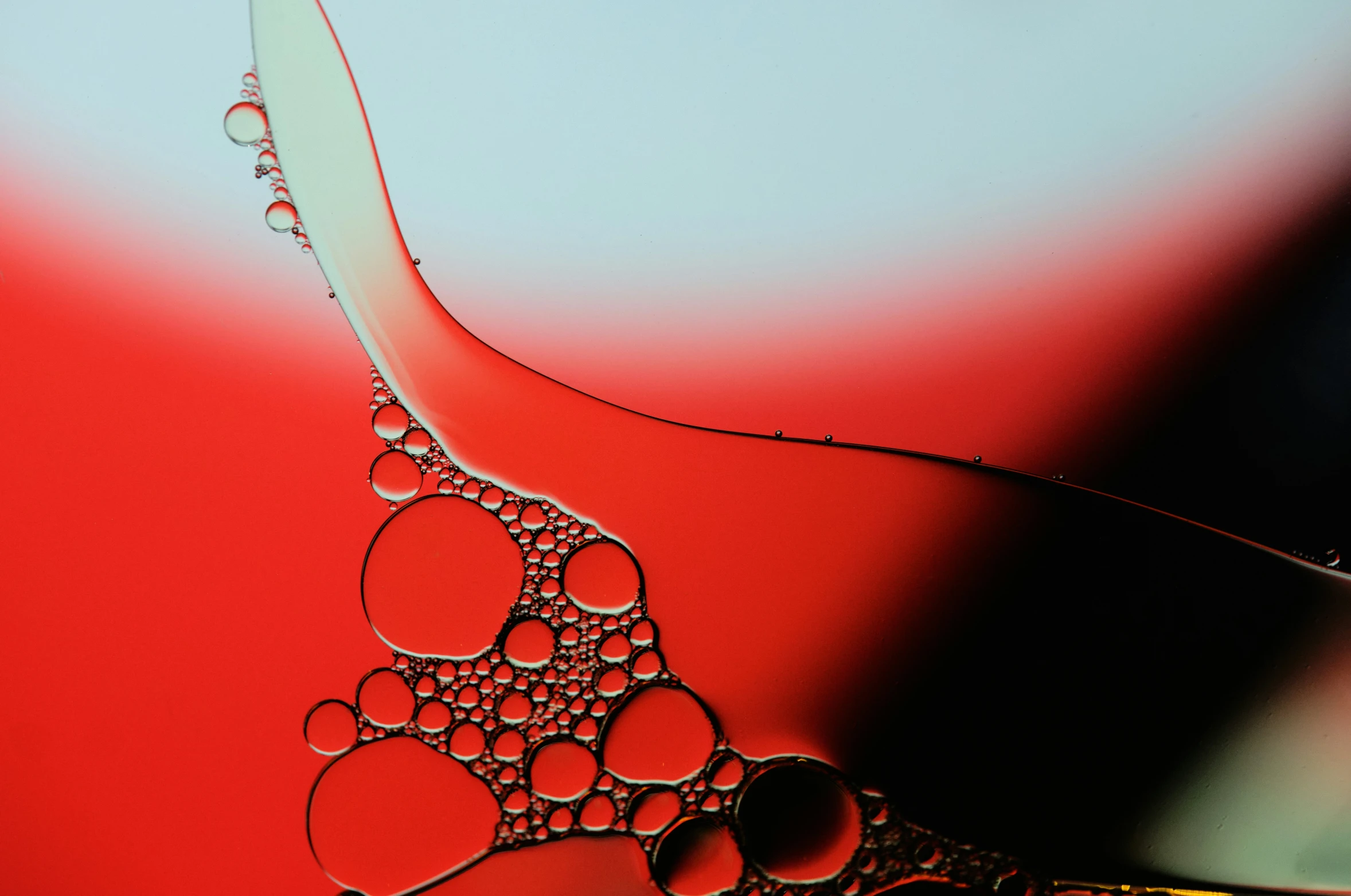 water droplets floating from a red and black object