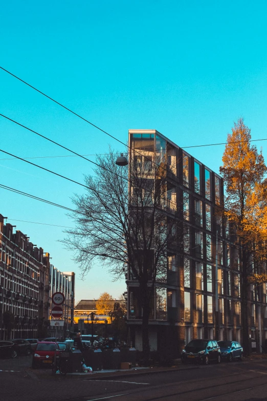 a tall building with lots of windows next to a street