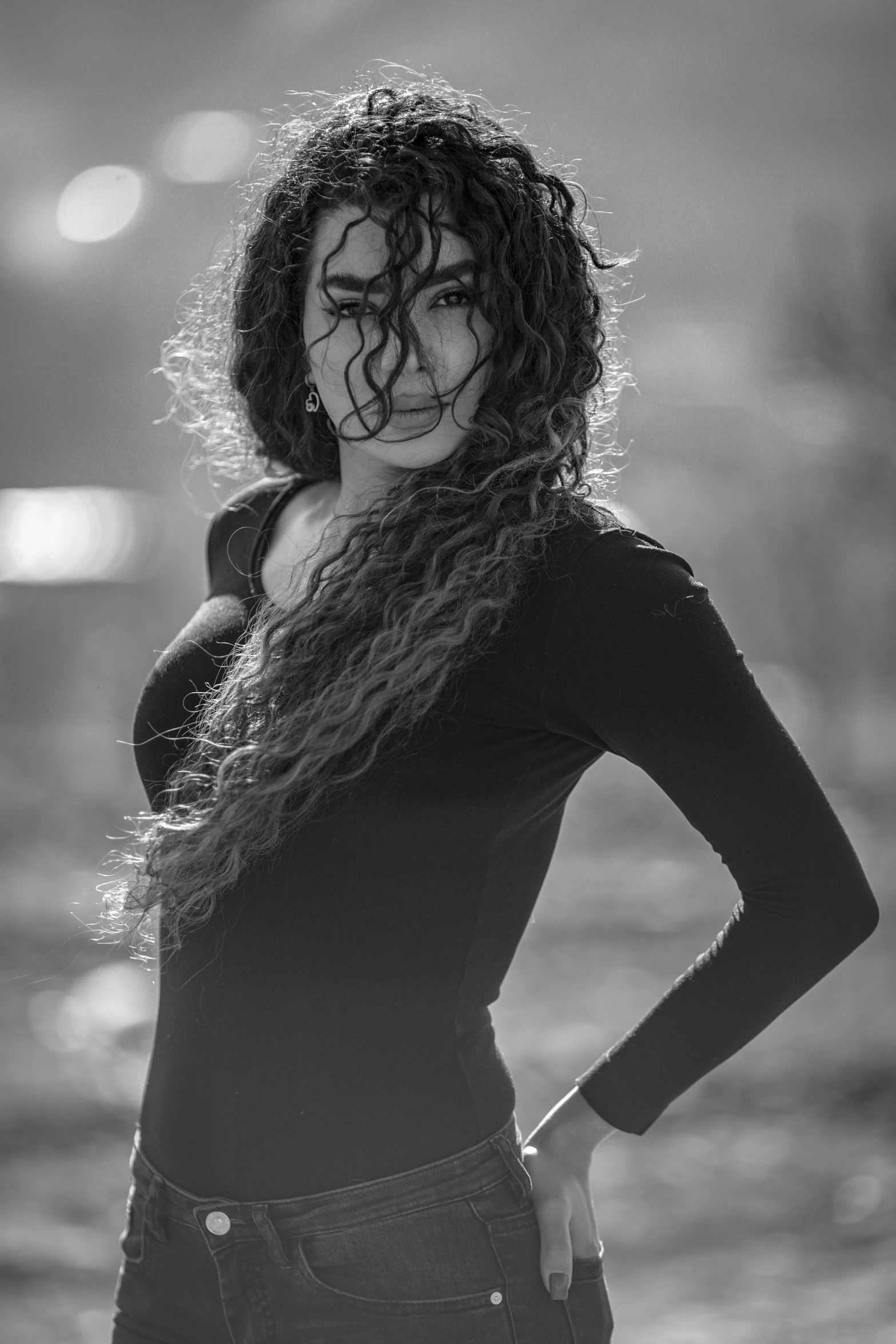 a woman is posing with her arms crossed