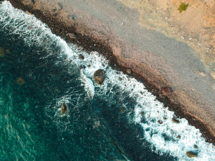 this is an aerial view of the coast with the water and shore