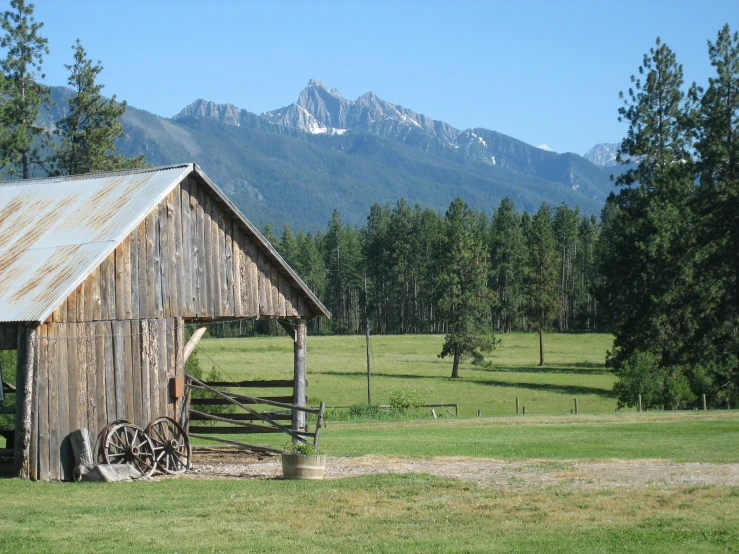 an old barn in the mountains near trees