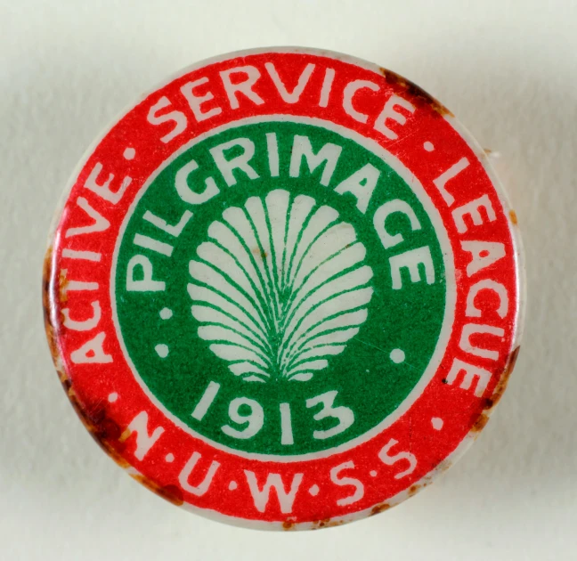 a closeup of a pin badge with an advertit on it